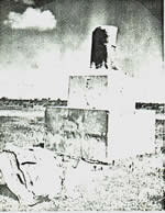 photograph of the rear view of the La Salle monument showing broken parts of the body of the statue